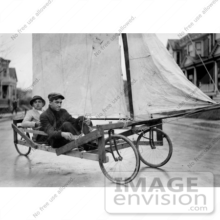 #27639 Stock Photo of Two Men Having Fun And Pedaling Down The Street On A Sail Wagon, Also Known As A Sand Yacht Or Land Yacht, Brooklyn, New York by JVPD