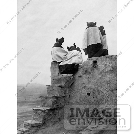 #30218 Stock Photo of The Backs Of Four Hopi Native American Women Seated On A Roof At The Top Of Stairs On A Walpi Pueblo, 1904 by JVPD