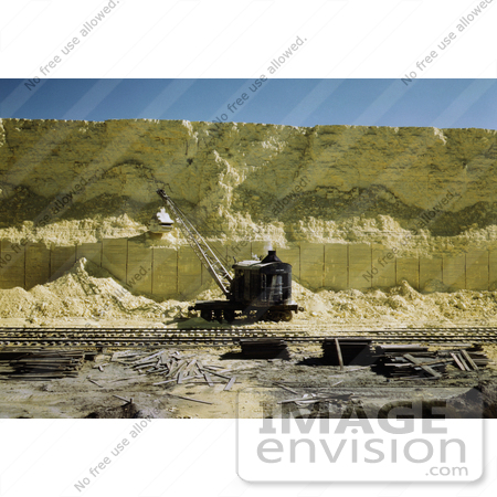 #30943 Stock Photo of a Dragline Excavator Scooping Sulphur From A 60 Foot High Vat In Front Of The Railroad At The Freeport Sulphur Company In Hoskins Mound, Texas by JVPD