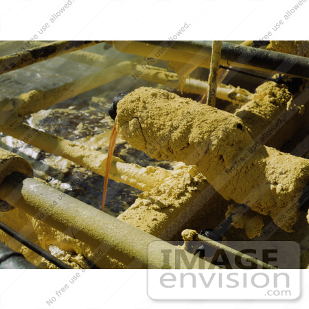 #30947 Stock Photo of Sulphur Covered Faucet Pouring Melted Sulphur From The Wells Into The Relay Station At The Freeport Sulphur Company In Hoskins Mound, Texas by JVPD