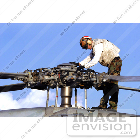 #35229 Stock Photo of Aviation Electrician’s Mate 2nd Class Justin Williams Conducting A Pre-Flight Check On A Seahawk Propeller by JVPD