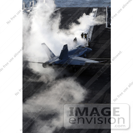 #35236 Stock Photo of an F/A-18C Hornet Aircraft Maneuvering Through The Steam Of Catapult Two As It Prepares To Launch From The Flight Deck Of The Nimitz-Class Aircraft Carrier USS Ronald Reagan by JVPD