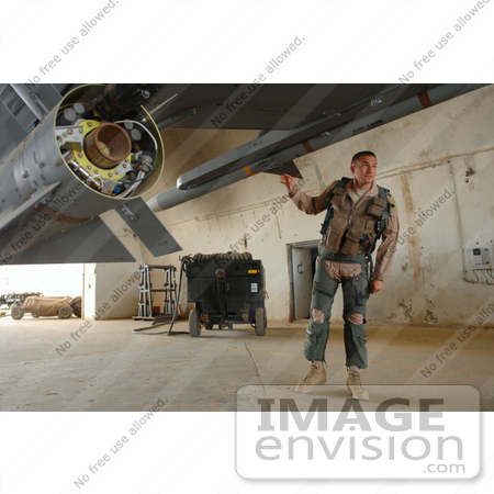 #35238 Stock Photo of a U.S. Air Force Pilot Capt. Bart Wilbanks Performing A Preflight Inspection On An F-16 Fighting Falcon Aircraft On Balad Air Base, Iraq by JVPD