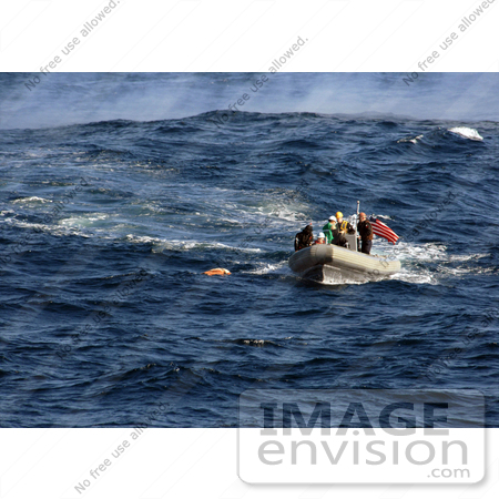 #35248 Stock Photo of U.S. Navy Sailors Using A Rigid Hull Inflatable Boat To Approach A Practice Dummy During A Man Overboard Drill While Under Way In The Pacific Ocean by JVPD