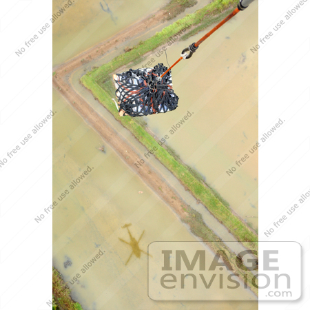#35251 Stock Photo of a HH-60H Seahawk Helicopter Carrying A Pallet Of Water To Kalibo, Philippines, For Humanitarian Assistance And Disaster Relief To Victims Of Typhoon Fengshen by JVPD