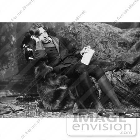 #35628 Stock Photo of Oscar Wilde, Reclined On A Sofa, Holding A Book And Leaning His Head On His Hand by JVPD