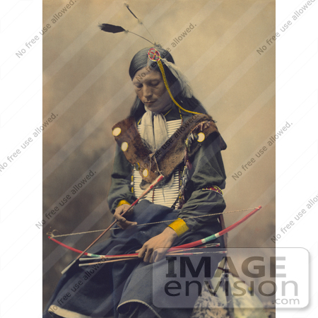 #35637 Stock Photo of a Native American Named Bone Necklace, Council Chief, Oglala Sioux, Seated With A Bow And Arrows And Looking Down by JVPD