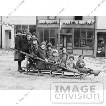 #35664 Stock Photo Of A Group Of Children Posing On A Sled In The Middle Of A Village Street In Seward, Alaska by JVPD