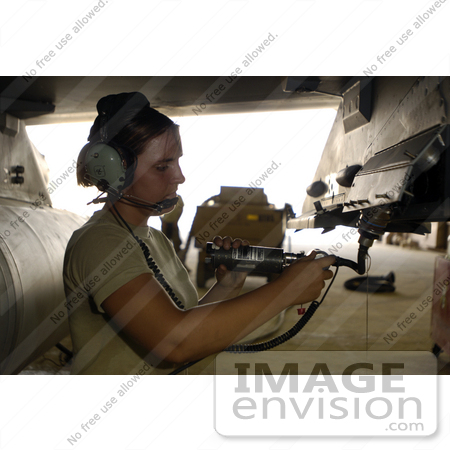 #35683 Stock Photo of a Female United States Air Force Soldier Performing a Preload Check on an F-16 Fighting Falcon Aircraft in Iraq by JVPD
