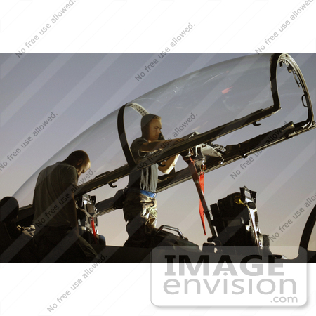 #36174 Stock Photo of a Man Inspecting the Cockpit of an F-15E Eagle Aircraft by JVPD