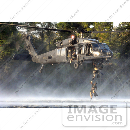 #36184 Stock Photo of U.S. Air Force Pararescuemen Climbing A Ladder To A U.S. Army MH-60 Black Hawk Helicopter by JVPD