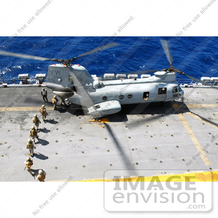 #36185 Stock Photo of Marines Loading Into A CH-46E Sea Knight Helicopter For A Fast-Rope Training Exercise by JVPD