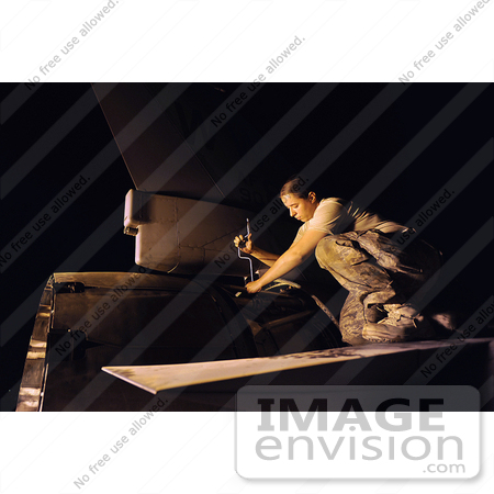 #36193 Stock Photo Of A Female Soldier Tightening Clamps Around An Actuator On An F-16 Fighting Falcon by JVPD