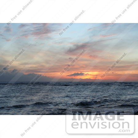 #36511 Stock Photo of a Hawaiian Sunset Of Pink And Orange Clouds With Some Blue Sky Over The Ocean, Poipu, Kauai, Hawaii by Jamie Voetsch