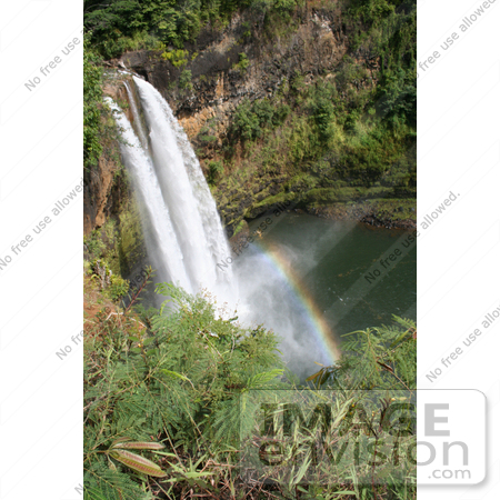 #36528 Stock Photo of The Wailua Falls Flowing Over The Cliffs Into The Pool Below, Its Mist Creating A Rainbow, Kauai, Hawaii by Jamie Voetsch