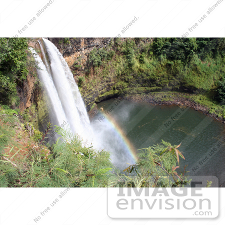 #36530 Stock Photo of The Wailua River Forming The Wailua Falls As It Flows Over The Red Cliffs Into The Pool Below, With A Rainbow, Kauai, Hawaii by Jamie Voetsch
