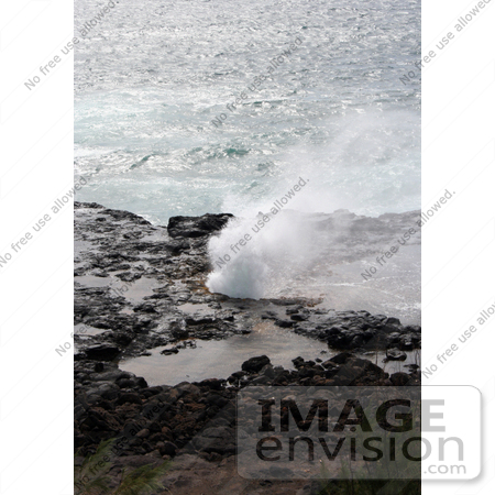 #36533 Stock Photo of The Blowhole Of Spouting Horn Spraying Water Against A Backdrop Of The Pacific Ocean, Poipu, Kauai, Hawaii by Jamie Voetsch