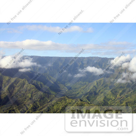 #36538 Stock Photo of an Aerial View Of The Valley Leading To The Heart Of Mount Waialeale, With A Green Landscape And Puffy White Clouds by Jamie Voetsch