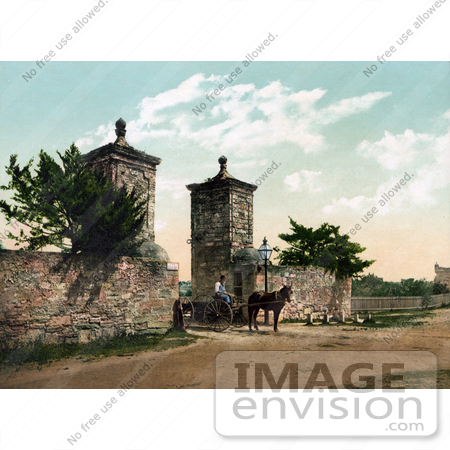 #40906 Stock Photo of a Horse Pulling A Man In A Wagon Through The Old City Gate In St. Augustine, Florida by JVPD