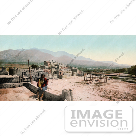 #40932 Stock Photo Of A Native American Seated On A Wall At Pueblo De Taos, New Mexico by JVPD