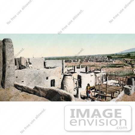 #41015 Stock Photo Of A Pueblo Native Standing Among Village Buildings In New Mexico by JVPD