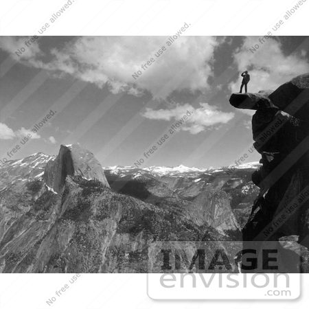 #41171 Stock Photo Of A Lone Man Standing On An Overhanging Rock Cliff At Glacier Point, With A View Of Half Dome And The Valley Of Yosemite National Park, California by JVPD