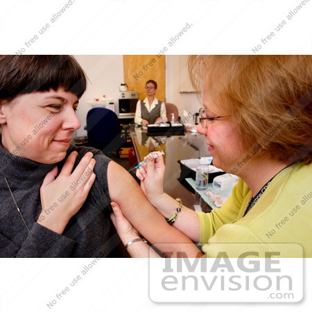 #5150 Stock Photography of a Nurse Giving a Flu Shot to Her Patient by JVPD