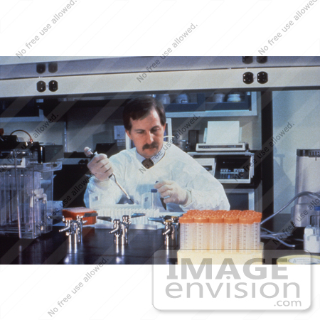 #5212 Picture of a Lab Technician Pipetting Specimens While he Conducts Laboratory Research by JVPD