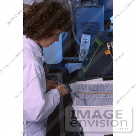 #5323 Picture of a Scientist Using a Multi-Channel Pipette to Dispensing Lab Samples by JVPD