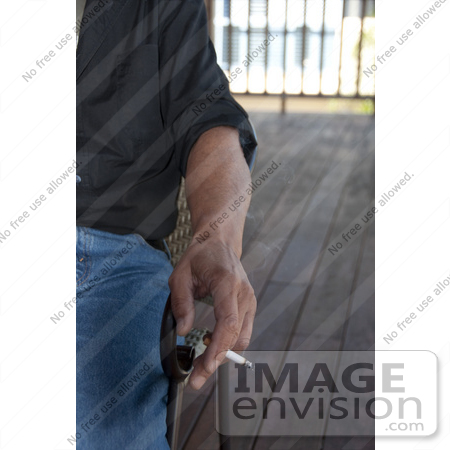 #53728 Royalty-Free Stock Photo of a Hand Holding Cigarette by Maria Bell