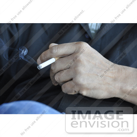 #53730 Royalty-Free Stock Photo of a Hand Holding Cigarette by Maria Bell