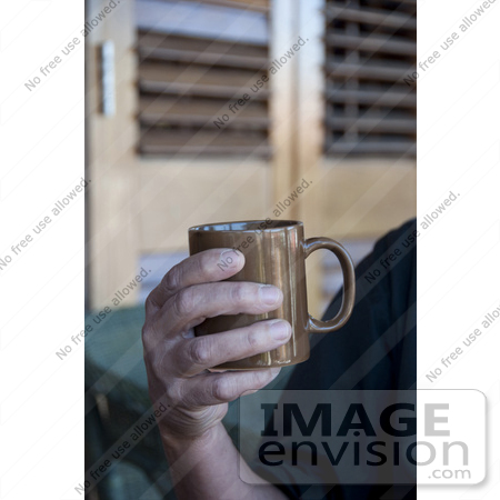 #53732 Royalty-Free Stock Photo of a Man Holding A Hot Drink In A Mug by Maria Bell