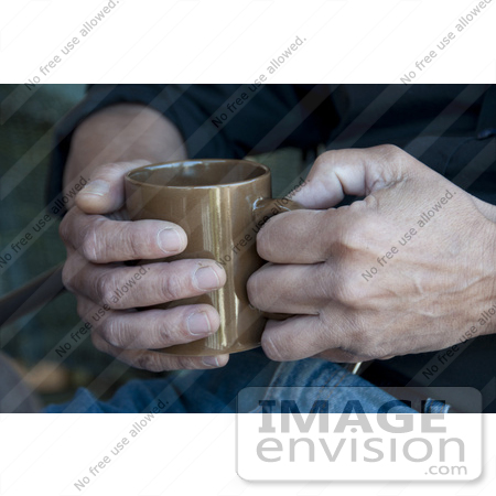 #53734 Royalty-Free Stock Photo of a Man Holding A Hot Drink In A Mug by Maria Bell