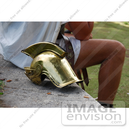 #53777 Royalty-Free Stock Photo of a Man Sitting by a Helmet by Maria Bell