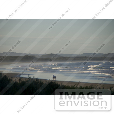 #53866 Royalty-Free Stock Photo of people strolling on a beach by Maria Bell