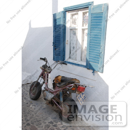 #53884 Royalty-Free Stock Photo of an old motorcycle by a window by Maria Bell