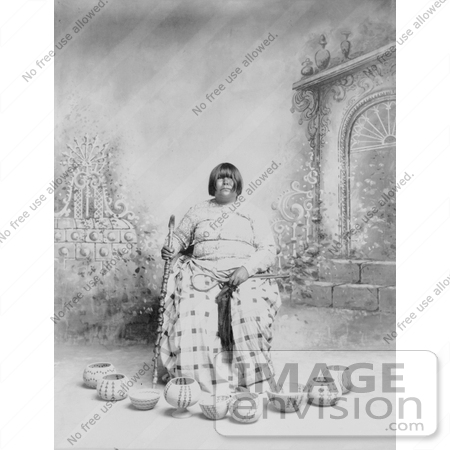 #6132 Stock Photo of a Washoe Native American Woman Sitting in a Chair, Surrounded by Baskets by JVPD