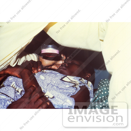 #6296 Picture of a Doctor Taking an Eye Scraping from a Lassa Fever Patient by KAPD