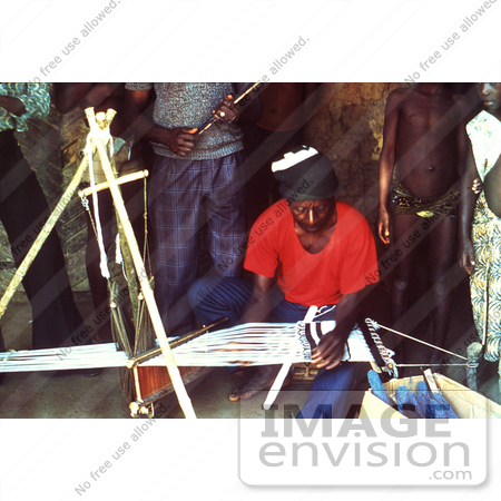 #6302 Picture of a Villagers Watching a Motehun, Sierra Leone Weaver Practicing His Craft by KAPD