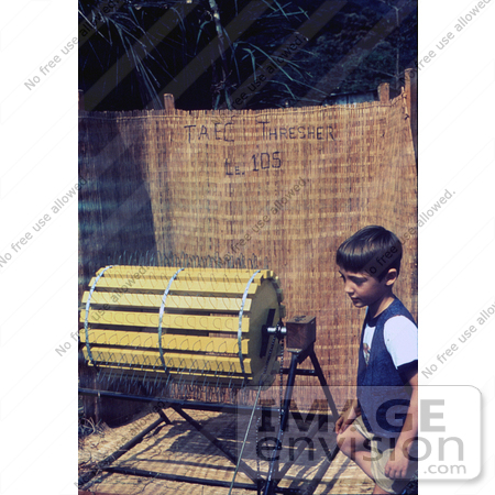 #6433 Picture of a Boy Standing Beside a Rice Threshing Machine at a 1976 Sierra Leone Lassa Fever Field Study by KAPD