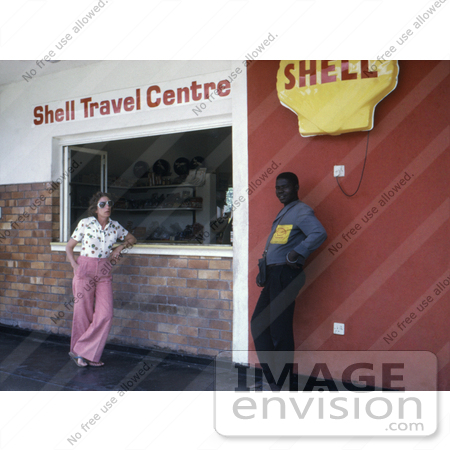 #7323 Picture of a Man and Woman Standing Outside of a Shell Gas Station Where Two People Became Ill with the Marburg Virus by KAPD