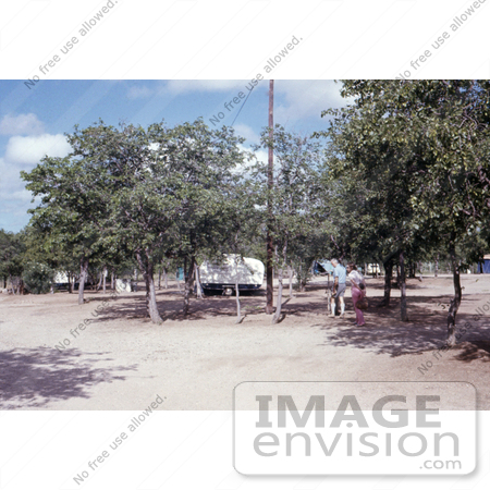 #7326 Picture of a Health Official Walking Through a Beitbridge, Rhodesian Campground During the Marburg Investigation of 1975 by KAPD