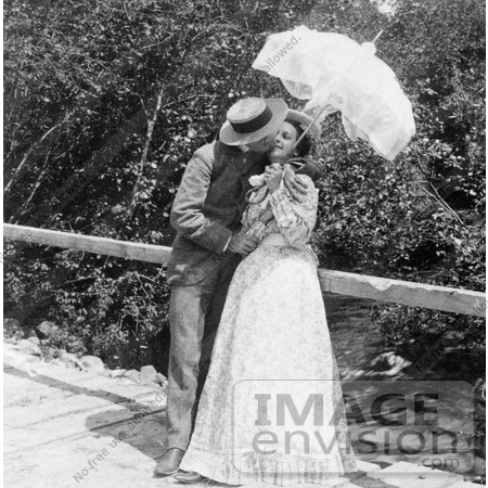 #7452 Stock Photo of a Man and Woman Kissing Under a Parasol by JVPD