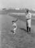 #25306 Sports Stock Photography of Babe Ruth and a Boy, Little Mascot, Posing With Bats on a Baseball Field by JVPD