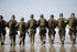 #36182 Stock Photo Of A Line Of Soldiers Walking Away Towards The Surf On A Beach by JVPD