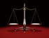#38134 Clip Art Graphic of a Balanced Brass Justice Scale, Symbolizing Equality, Over A Red And Black Background by Oleksiy Maksymenko