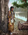 #40802 Stock Photo of a Young Native American Indian Girl Leaning Against A Tree Near A Boat On A River Bank, A Personification Of Minnehaha, 1904 by JVPD