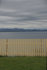 #53769 Royalty-Free Stock Photo of a Fence by a Beach by Maria Bell