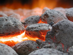 Charcoal Briquettes Burning in a BBQ Grill
