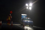 Road Construction Flagger at Night in the Rain